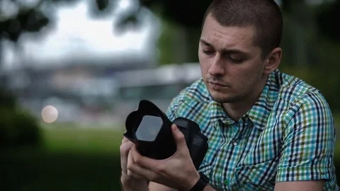 Man sets the camera before taking a picture Stock Footage 70681571