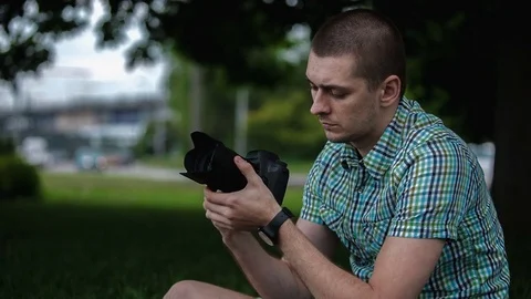 Man sets the camera before taking a picture Stock Footage 70681661