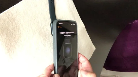 A man sets up the conjugation of smart watches Apple Watch Series 9 with hi.. Stock Footage 279739382