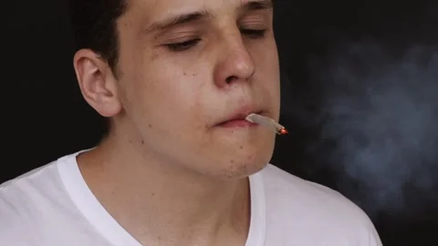 A man sets fire to cigarettes and smokes it 스톡 동영상 144697996