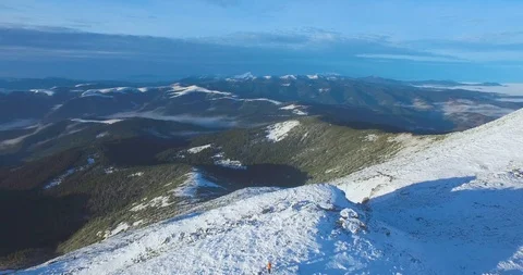 Man sets flag on mountain Stock Footage 93899227
