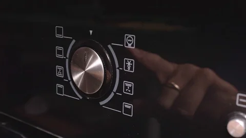 A man sets the operation mode of the electric box. The electric oven oven Stock Footage 108055780