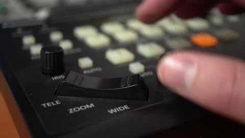A man sets up remotely controlled cameras. Camera control panel. Hand close up. Stock Footage 233332015
