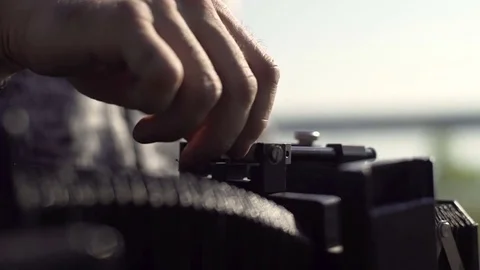 Man sets retro camera. Close-up of hands Stock Footage 72104162