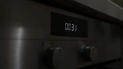 The Man Sets Up Silver Gray Built-in Oven Alarm Clock And The Countdown Begins Stock Footage 141052930