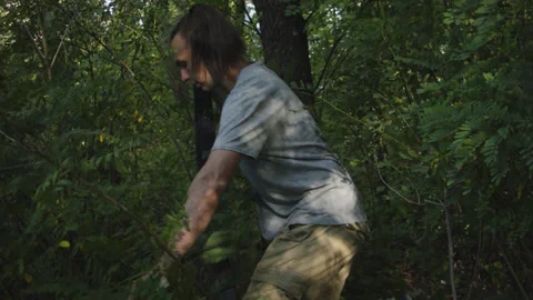 Man sets slackline between trees above the river. 스톡 동영상 140766442