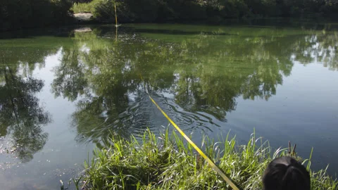 Man sets slackline between trees above the river. 스톡 동영상 140799611
