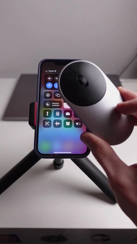 A man sets up a smartphone to work with a mouse via bluetooth Stock Footage 237762842