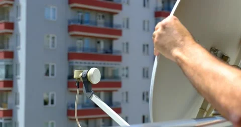 Man Sets Up a Terrestrial Satellite Dish 動画素材 196872915