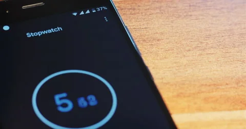 Man sets time in application on smartphone on wooden table Vídeo Stock 149461936