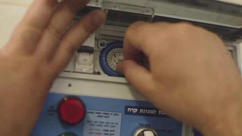 A Man Sets a Time switch Stock Footage 87869716
