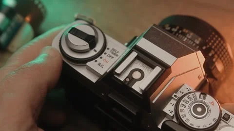 Man sets up a vintage camera and takes a photo Stock Footage 295026584
