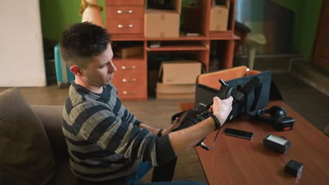 Man setting up camera and microphone in home studio Stock Footage 317590382