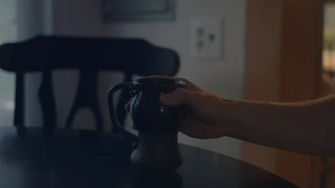 Man setting down and drinking from a cup of coffee in 4k. Stock Footage 93612030