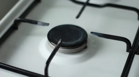 Man setting fire to a gas stove with handle lighter 動画素材 63456540