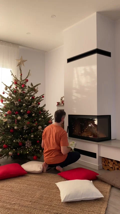 Man setting fireplace during Christmas time Stock Footage 277686310
