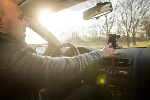Man setting up GPS on the mobile before his drive, asisstant during driving the Stock Photos