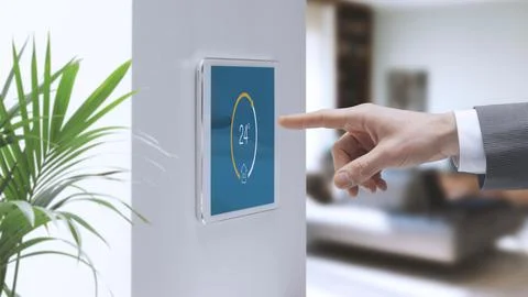 Man setting home temperature using a smart home system Stock Photos