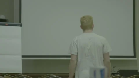 Man Setting Up Presentation Equipment in Auditorium Stock Footage 341863775