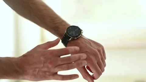 Man setting up smart watch Stock Footage 265724340