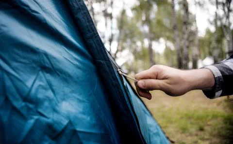 Man Setting Up Tent During Outdoor Camping Trip Stock Photos