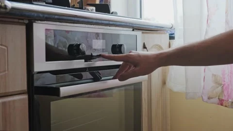 Man setting up the timer on the oven from a different angle v3 Stock Footage 163990855