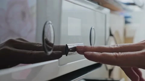 Man setting up the timer on the oven from a different angle v2 Stock Footage 165003232