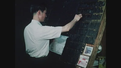Man setting type in Chinese for Chinese newspaper in Chinatown, New York, 1971 Stock Footage 82545973