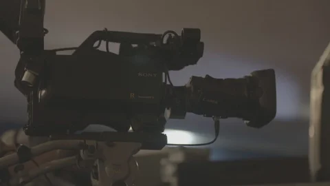 Man setups up camera for filming live event Stock Footage 98694431