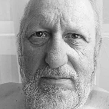 Man of seventy looking into the camera Stock Photos