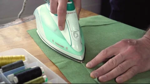 The man is sewing. Video stock 154860204