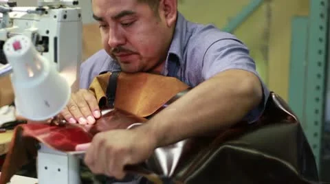 Man Sewing Leather for Furniture Couch Stock Footage