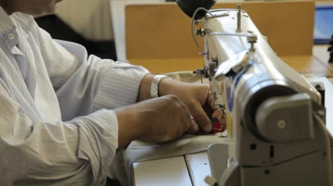 Man sewing with a sewing machine Stock Footage 31340998