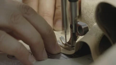 Man sewing on a sewing machine Stock Footage 276811085