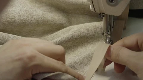 Man sewing on a sewing machine Stock Footage 276811144