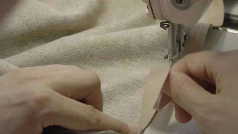 Man sewing on a sewing machine Stock Footage 276811157
