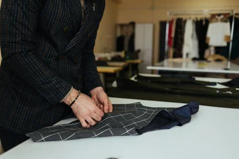 Man sews a button to his shirt Fotos de archivo