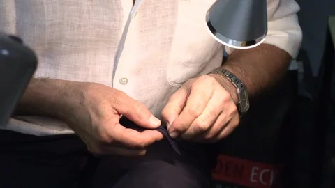 A man sews clothes in a hand Stock Footage 94361928