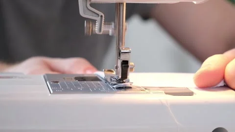A man sews clothes on sewing machine. Hobbies, needlework, creativity. Stock Footage 187016990