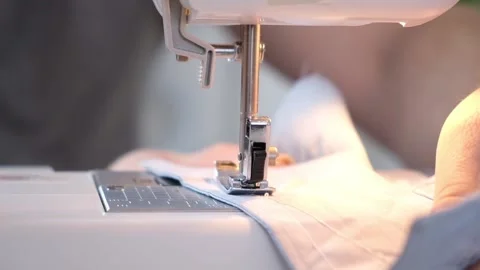 A man sews clothes on sewing machine. Hobbies, needlework, creativity. Stock Footage 192540823