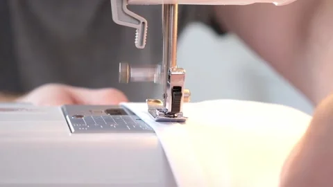 A man sews clothes on sewing machine. Hobbies, needlework, creativity. Stock Footage 197386423