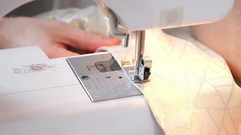 A man sews clothes on sewing machine. Hobbies, needlework, creativity. Stock Footage 198930818