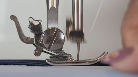 A man sews clothes while working on a sewing machine. Stock Footage 129646547