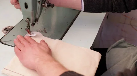 Man sews the fabric on the sewing machine Video stock 62672443