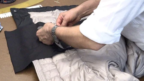 A man sews a jacket Stock Footage 94944640