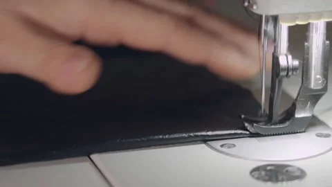 Man sews a line on a sewing machine Stock Footage 144108750