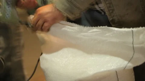 Man sews a sack of grain sewing machine Stock Footage 64555947
