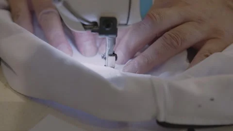 Man sews at a sewing machine. Designer sitting and sewing. Dressmaker working on Stock-Footage 254485081