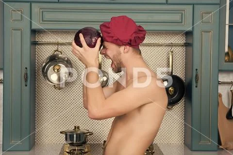 Man with sexy torso shout at purple cabbage Stock Photos