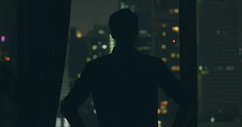 Man shadow silhouette stands panoramic windows apartment looking out, amazing Stock Footage 274652883